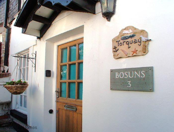 a sign on the side of a building with a door at 3 Bed in Torquay oc-h75059 in Torquay