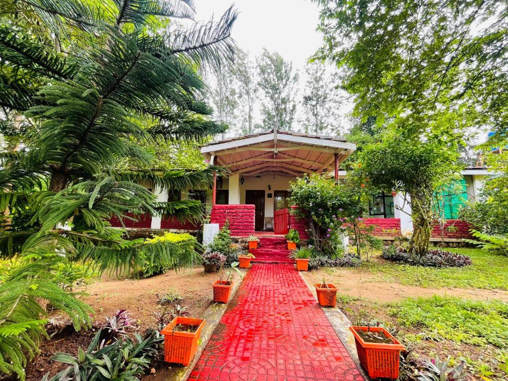 a red carpet path in front of a house at Wild Valley Club in Masinagudi