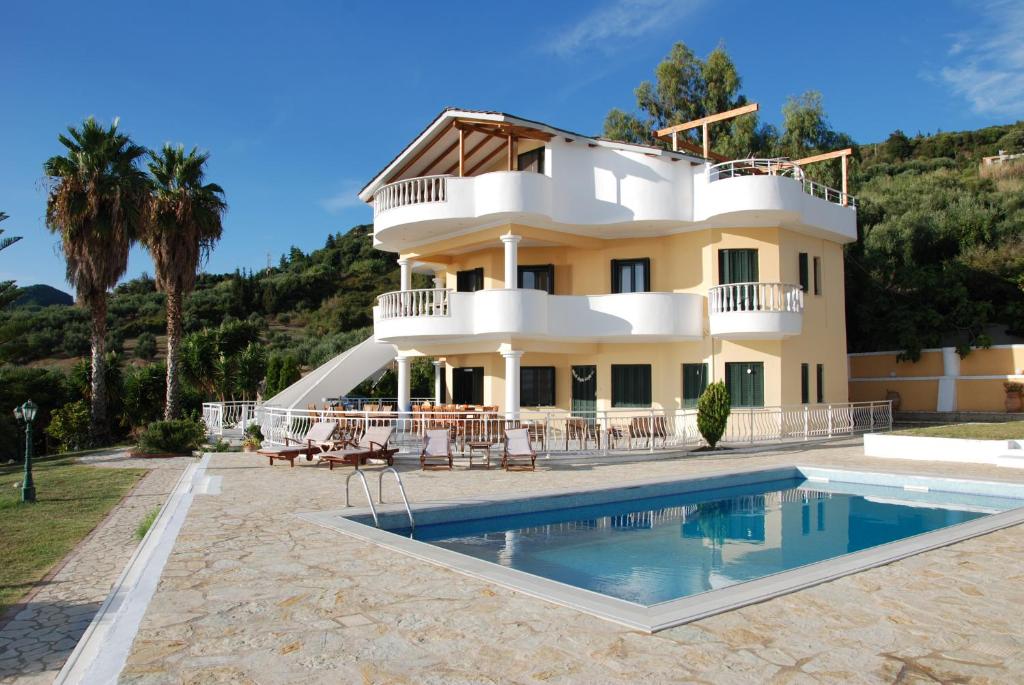 a house with a swimming pool in front of it at Villa Alex in Rizá