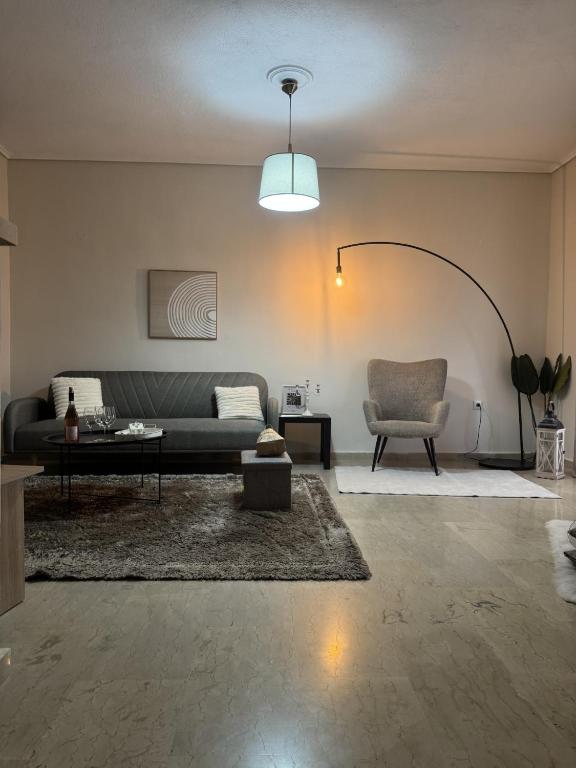a living room with a couch and a chair at Lithaia Aura-Trikala in Pýrgos