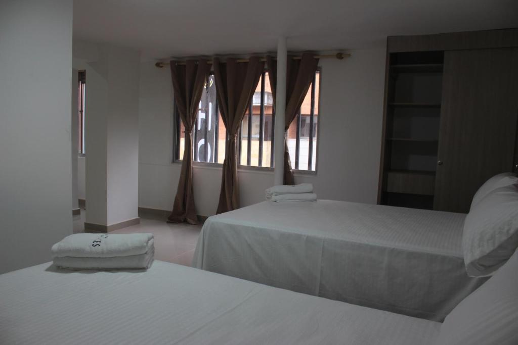 Ένα ή περισσότερα κρεβάτια σε δωμάτιο στο Hotel Ces