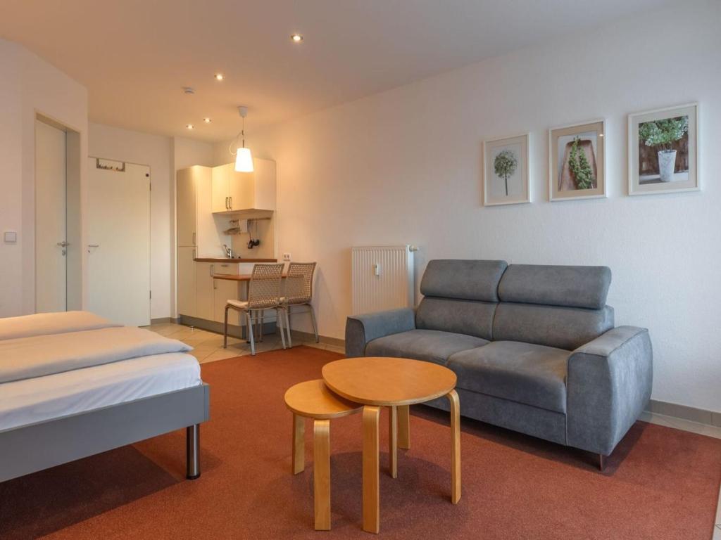 a living room with a couch and a table at Ferienwohnung im Aparthotel Seepanorama in Granzow