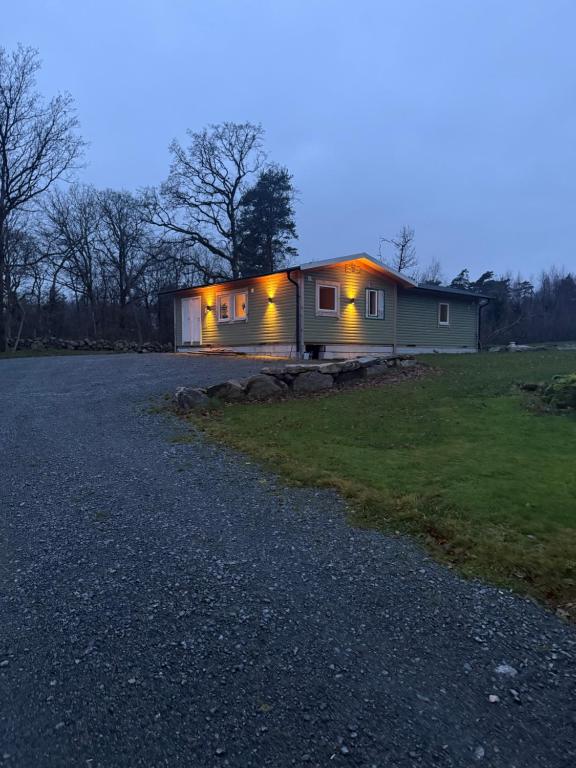 a house with lights on the side of it at Mysig stuga Buared - Family nature stay in Varberg