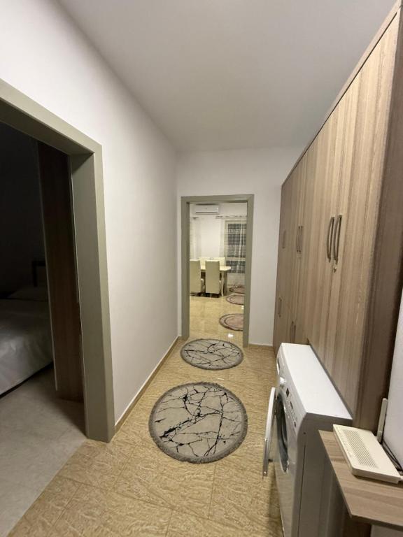 a hallway with two rugs on the floor in a room at Iljon Apartments in Tushemisht