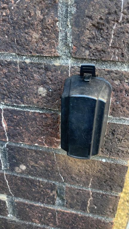 a black box on the side of a brick wall at 28 Russell road in Bristol