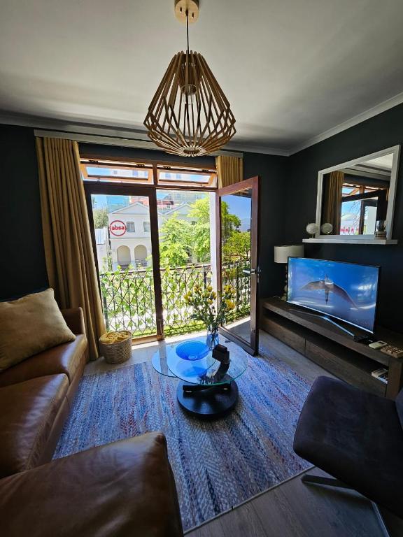 a living room with a couch and a table at At Leisure Apartment 2 in Stellenbosch