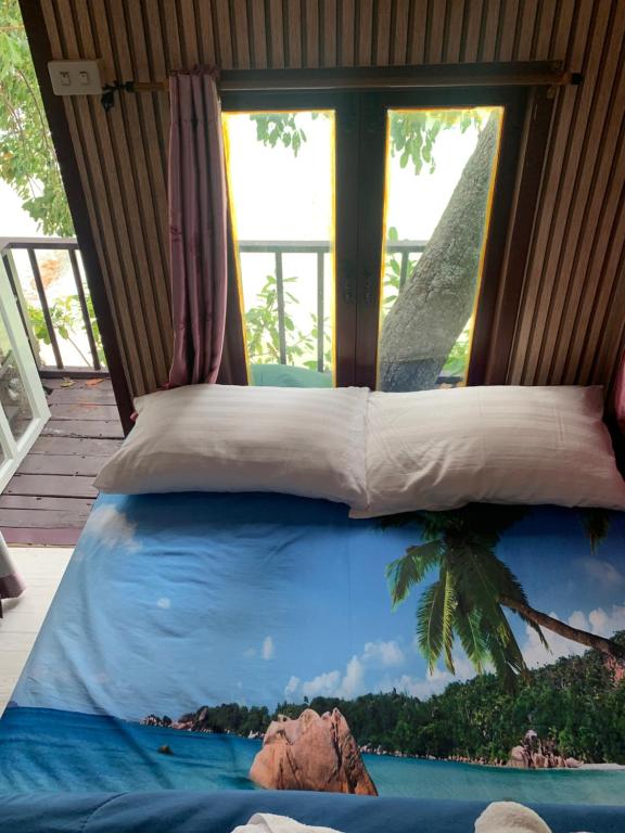 Ao PhutsaKoh Samed Lungdam Hutbeach เกาะเสม็ดลุงดำฮัทบีช的有窗户的房间里的一张床