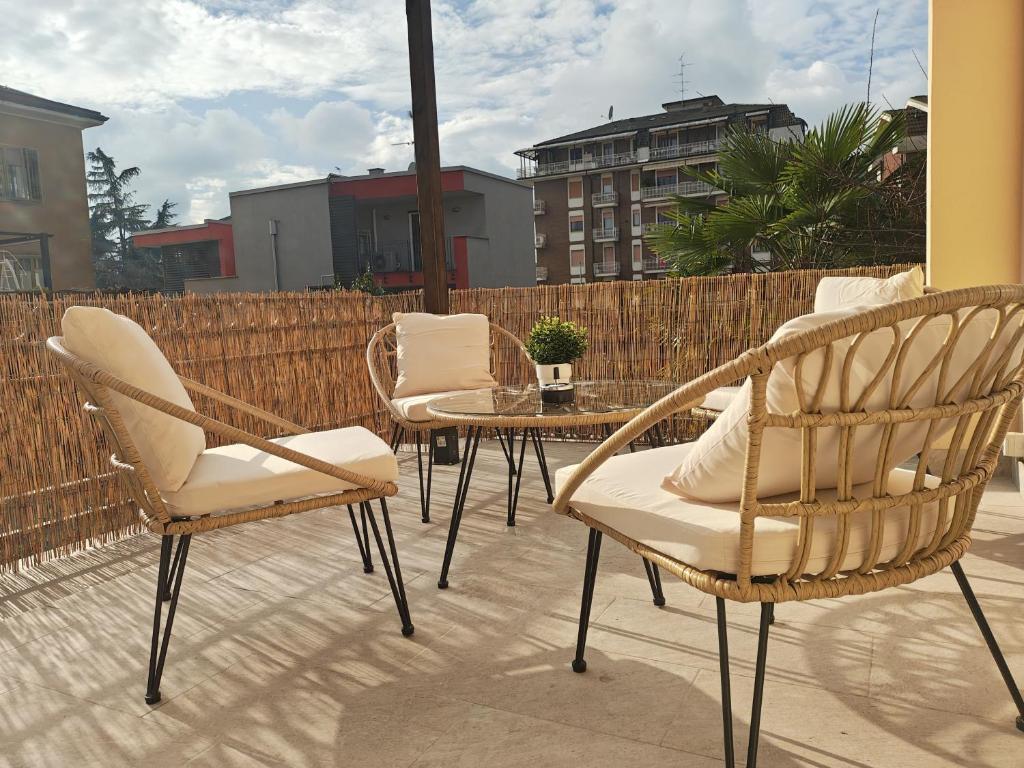 a patio with chairs and a table and a fence at Terrazza Groane in Garbagnate Milanese