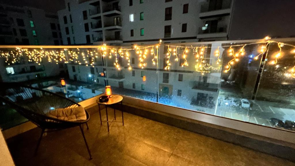 a balcony with a view of a building with lights at Luxury Apartment private parking in Craiova