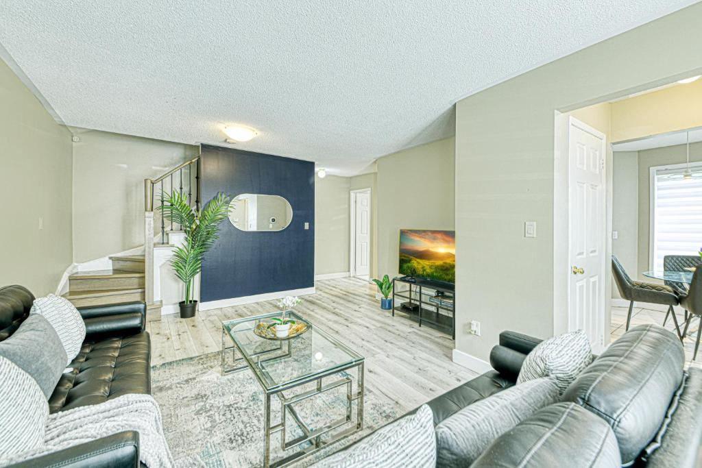 a living room with a couch and a table at The Urban Family Pad in Toronto