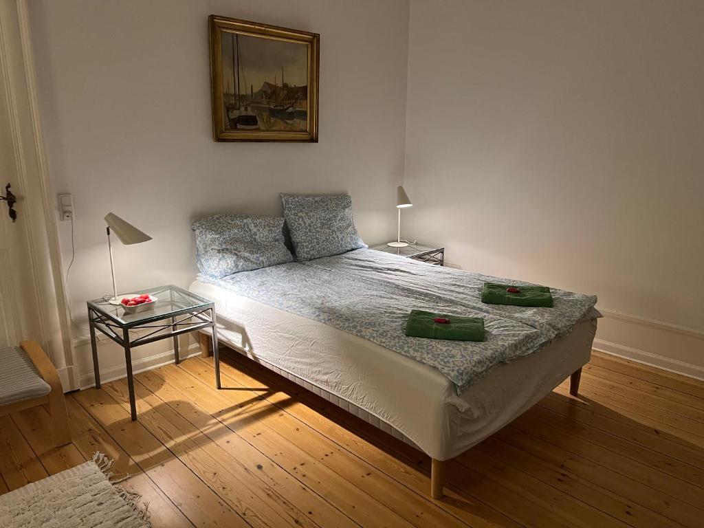 a bedroom with a bed and a side table at Topcity in Copenhagen