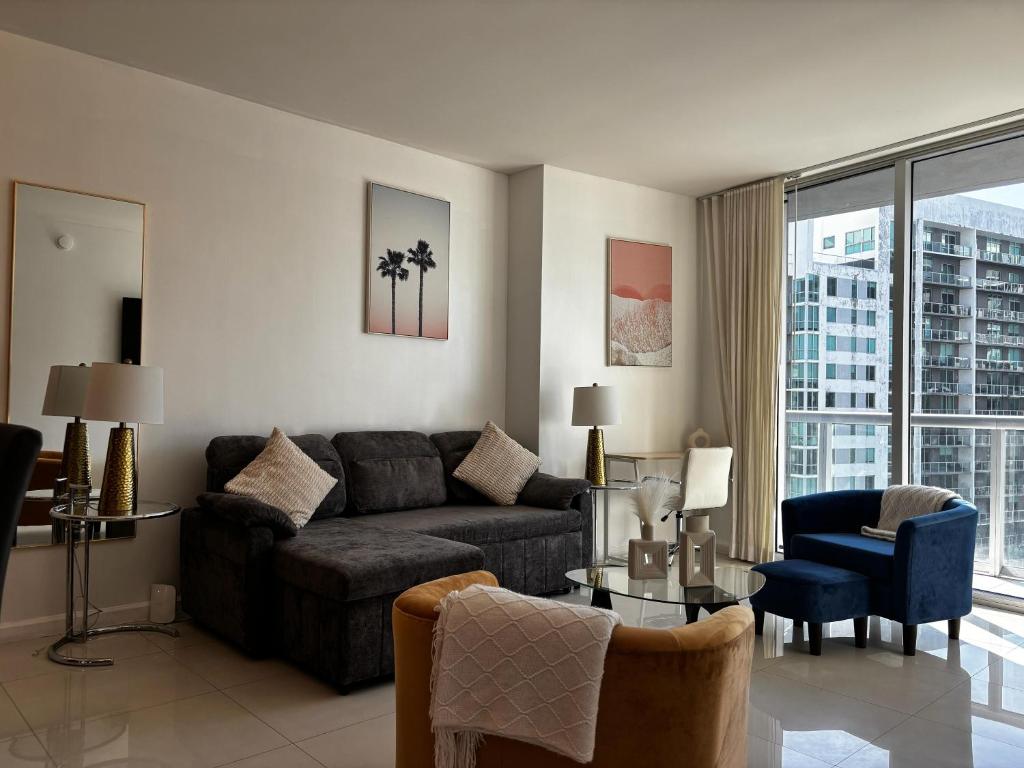 una sala de estar con un sofá y una mesa en ICON Brickell High Floor Condo - Balcony Skyline View - Amazing Spa, en Miami