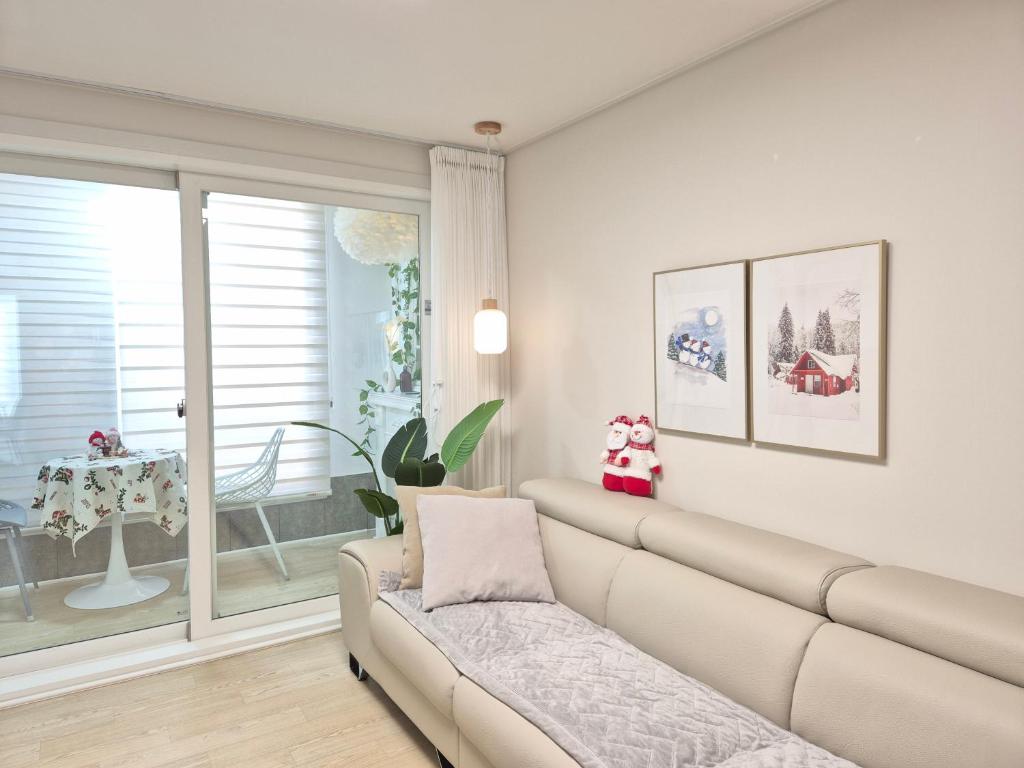 a living room with a couch and a window at Gyeongju Florian Stay Stay Close Explore More in Gyeongju