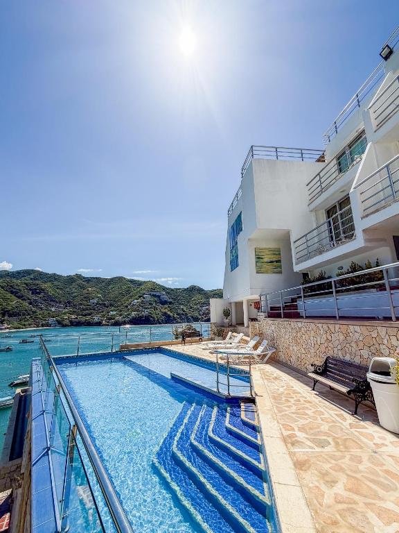 a large swimming pool next to a building at Hotel Bahia Taganga in Taganga