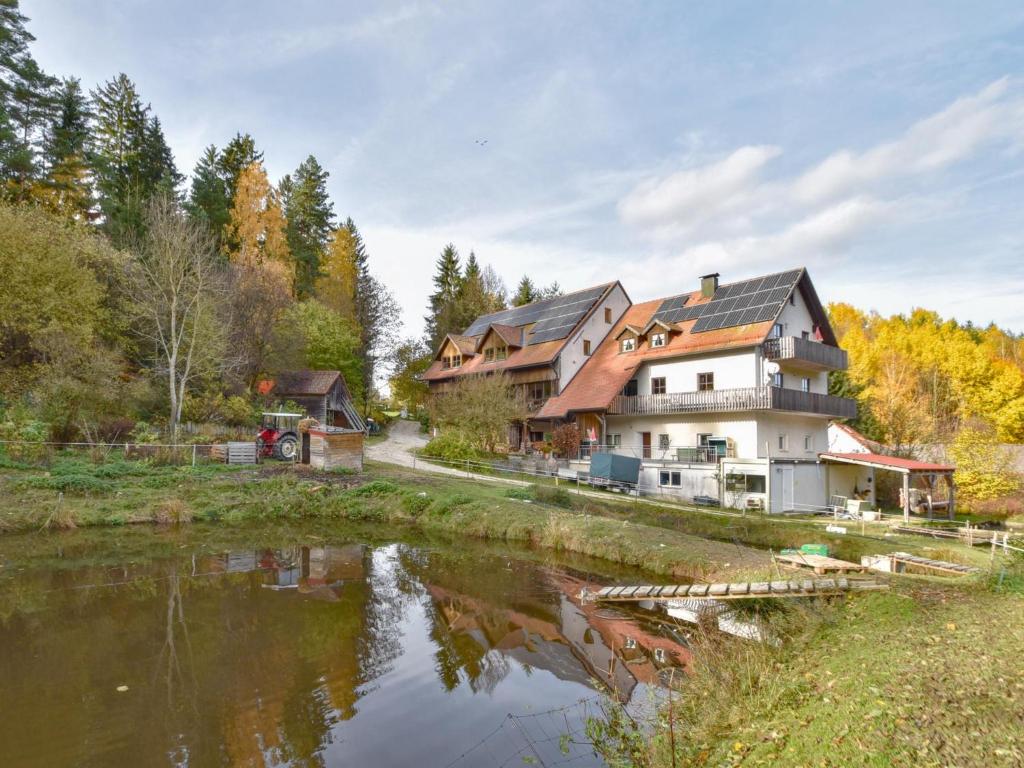 a large house is next to a river at Weiherblasch I in Schönsee