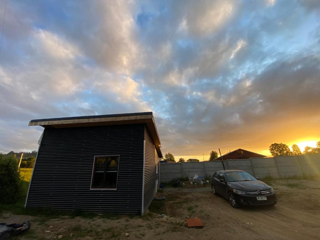 un coche aparcado frente a una casa pequeña en Departamento francisca, en Tey