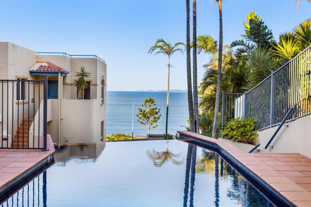 a house with a swimming pool with a view of the ocean at 'Villa Mar Colina U12' Coastal Escape, Yeppoon in Yeppoon