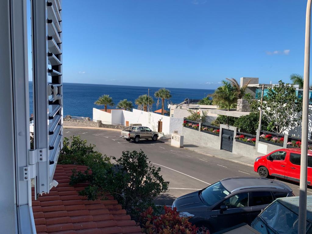 una strada con auto parcheggiate sul lato di un edificio di Casa 3 Soles a Morro del Jable