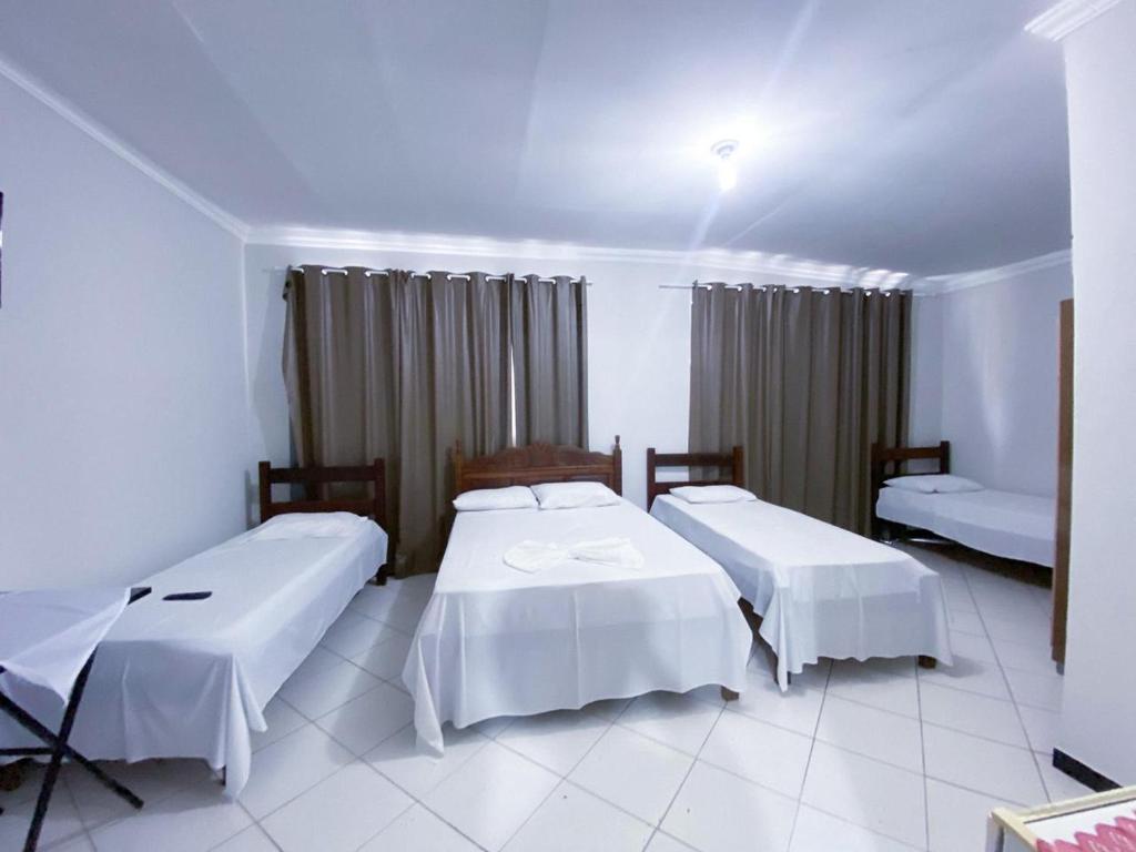 a hotel room with two beds in a room at Hotel Minas Brasil in Salinas