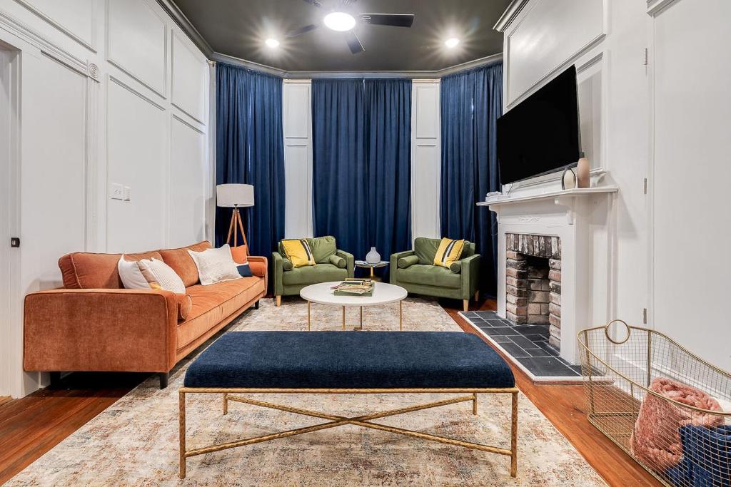 a living room with a couch and a fireplace at Nesting Escapes at Abercorn in Savannah