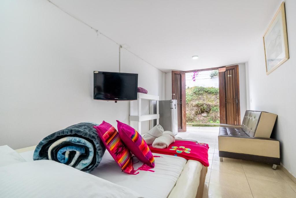 a room with a couch with colorful pillows on it at Mi Balconcito in Salento