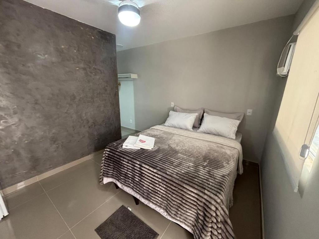 a small bedroom with a bed in a room at Cantinho da Ilha Suites in Abraão