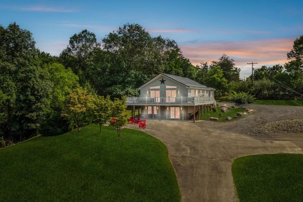 an aerial view of a house on a hill at Trailblazer Lodge - Upscale, hot tub, trail, game room, wifi, fire pit, bar, pool table, king bed, view, pet friendly in Berkeley Springs