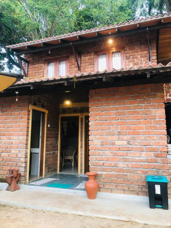 a brick house with an open door and a porch at RedBrick House Rumassala in Galle