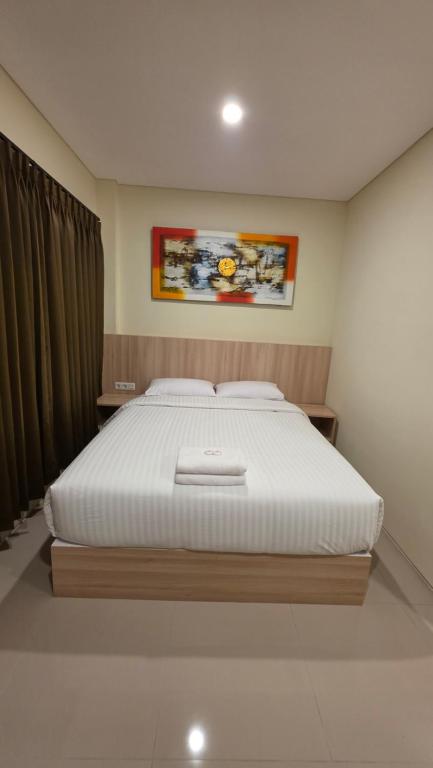 a bedroom with a large bed in a room at M3 Sanur Hotel in Sanur
