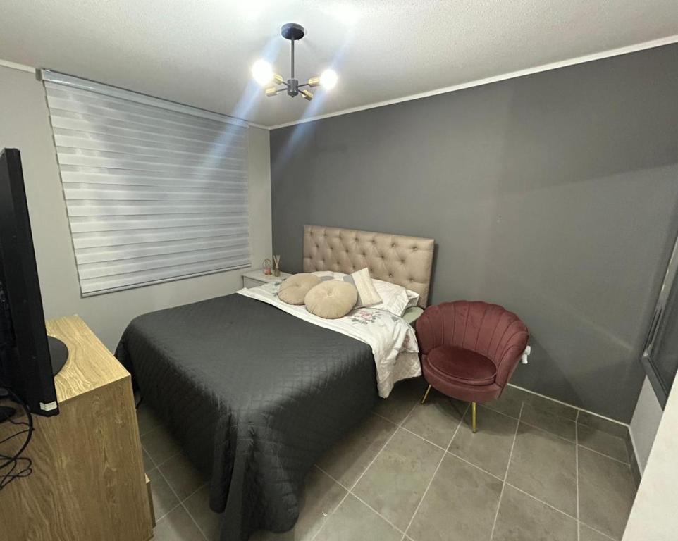 Giường trong phòng chung tại Depto TEMUCO CENTRO