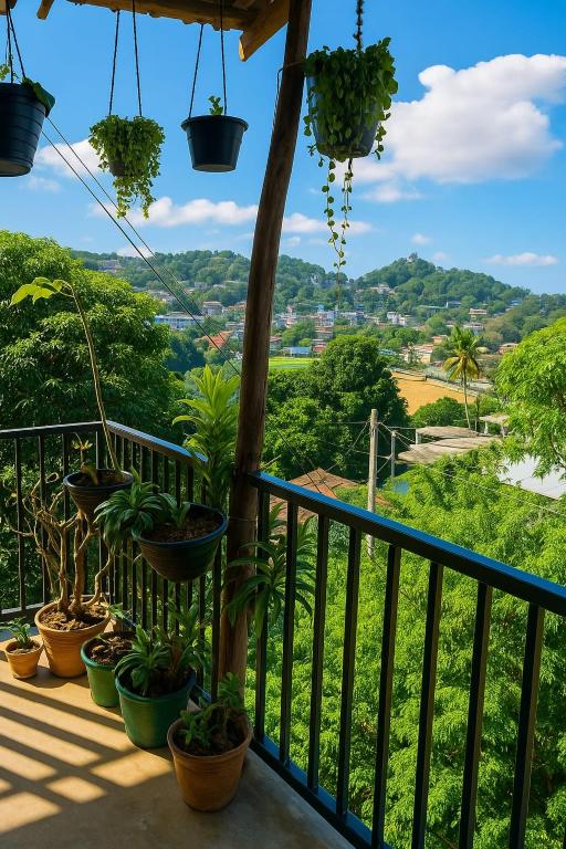 a balcony with potted plants and a view at S V homestay in Kandy