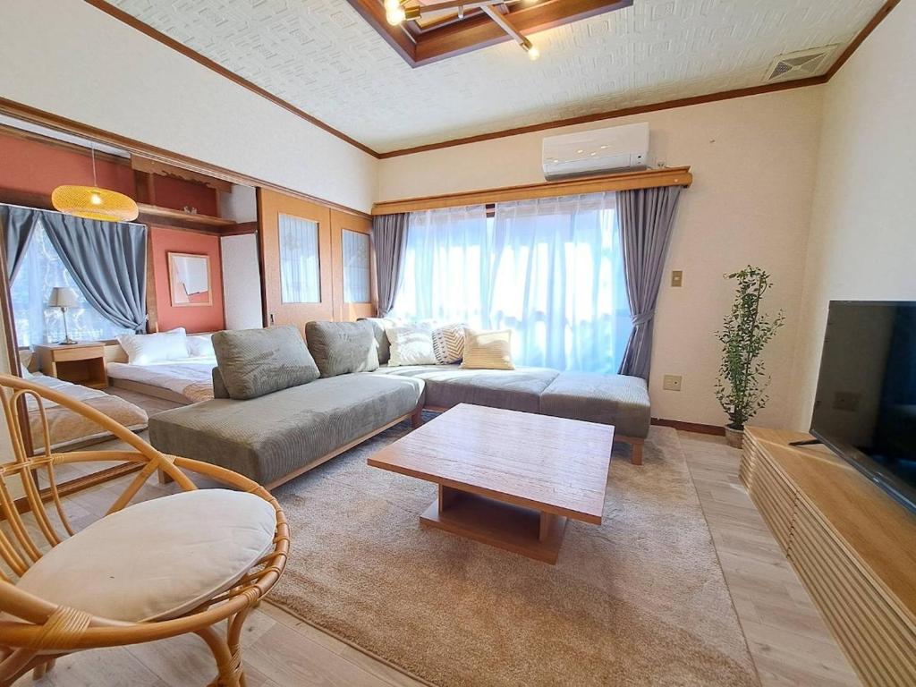 a living room with a couch and a table at 西逸見 in Yokosuka
