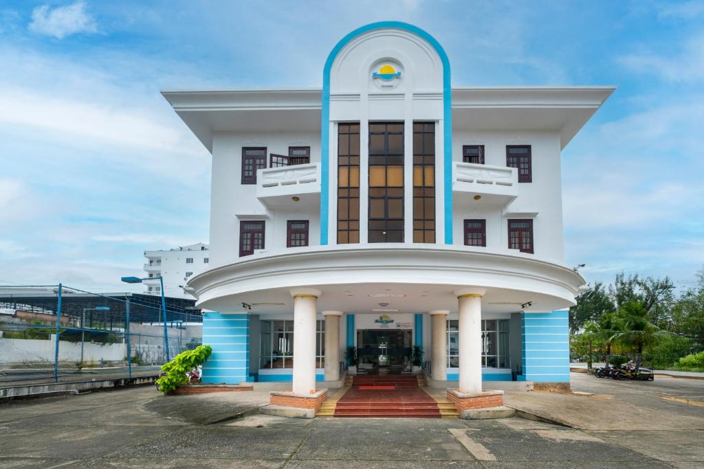 a large white building with a blue trim at Hawaii Resort Phu Quoc in Phu Quoc