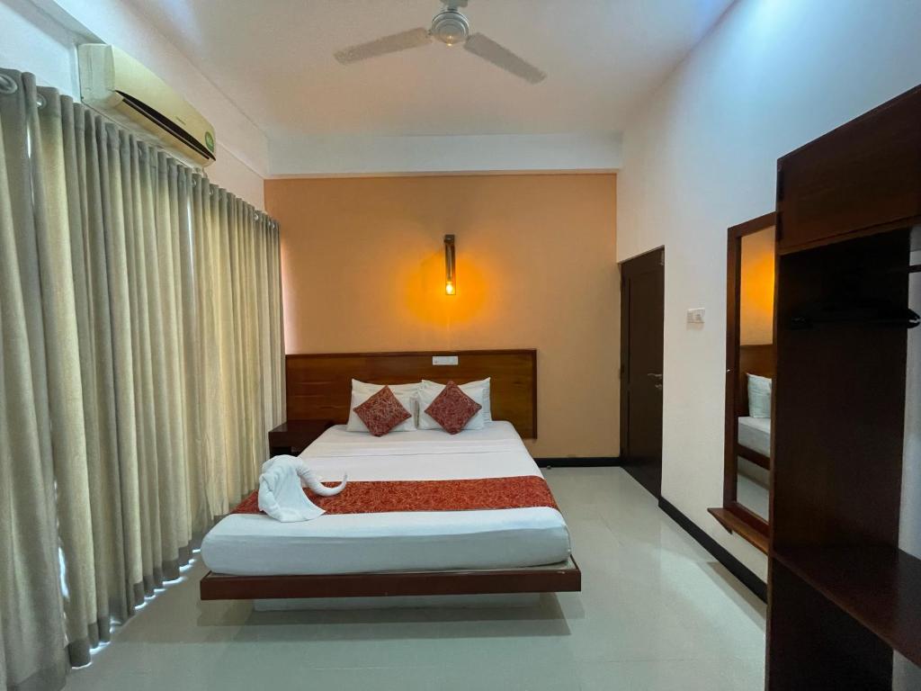 Ένα ή περισσότερα κρεβάτια σε δωμάτιο στο Sea cloud guesthouse dalawella