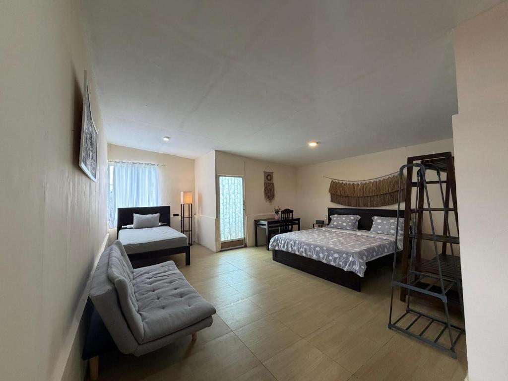 a bedroom with two beds and a chair and a ladder at MC Bunaken Stay Diving Trip's in Bunaken