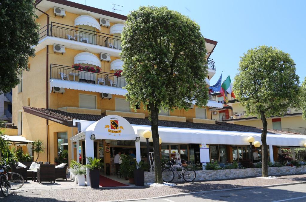 a building with a restaurant in front of it at Hotel Berna in Eraclea Mare