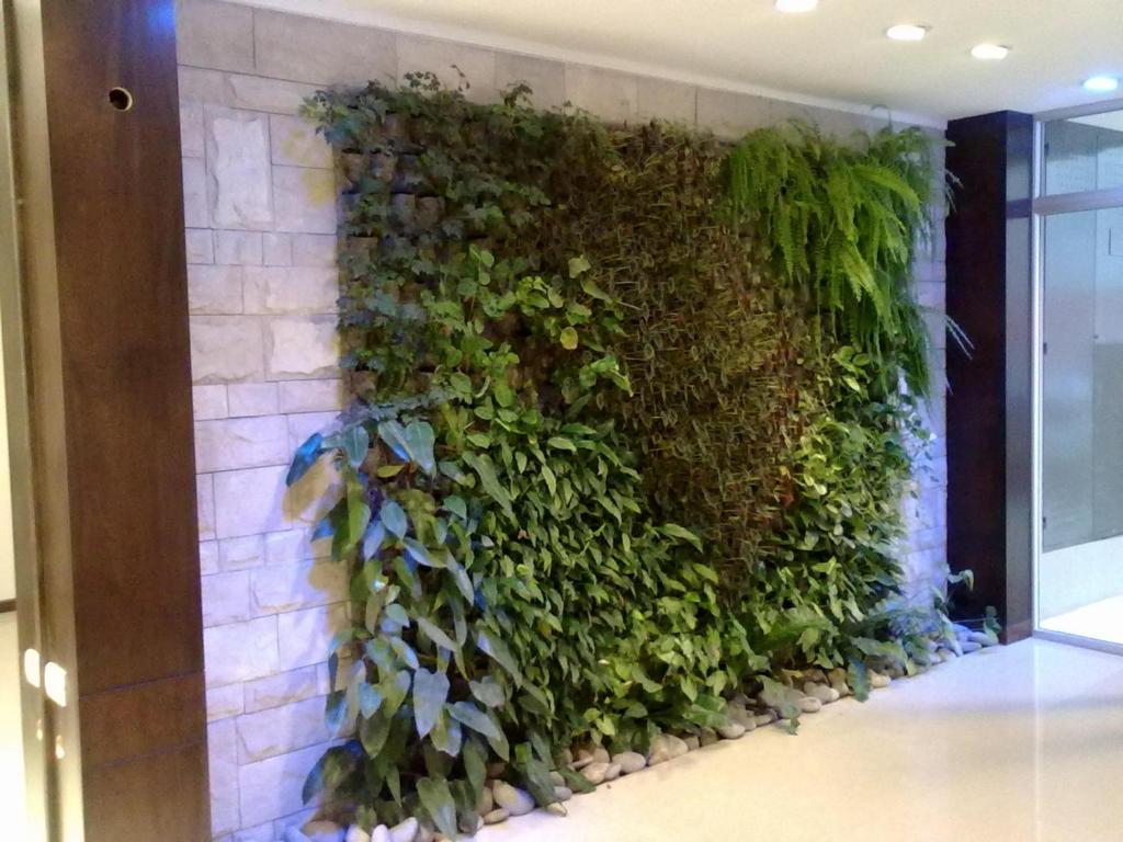 a green wall with plants on a wall at Roosevelt 1681 in Buenos Aires