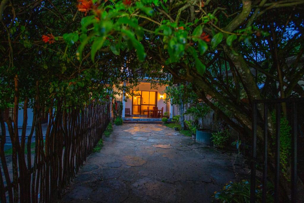 a walkway leading to a house with a fence at The Cloud Nest Villa in Ahangama