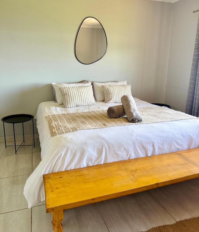 a bedroom with a large bed with a mirror on the wall at Kingfish Cove, Pennington in Kelso