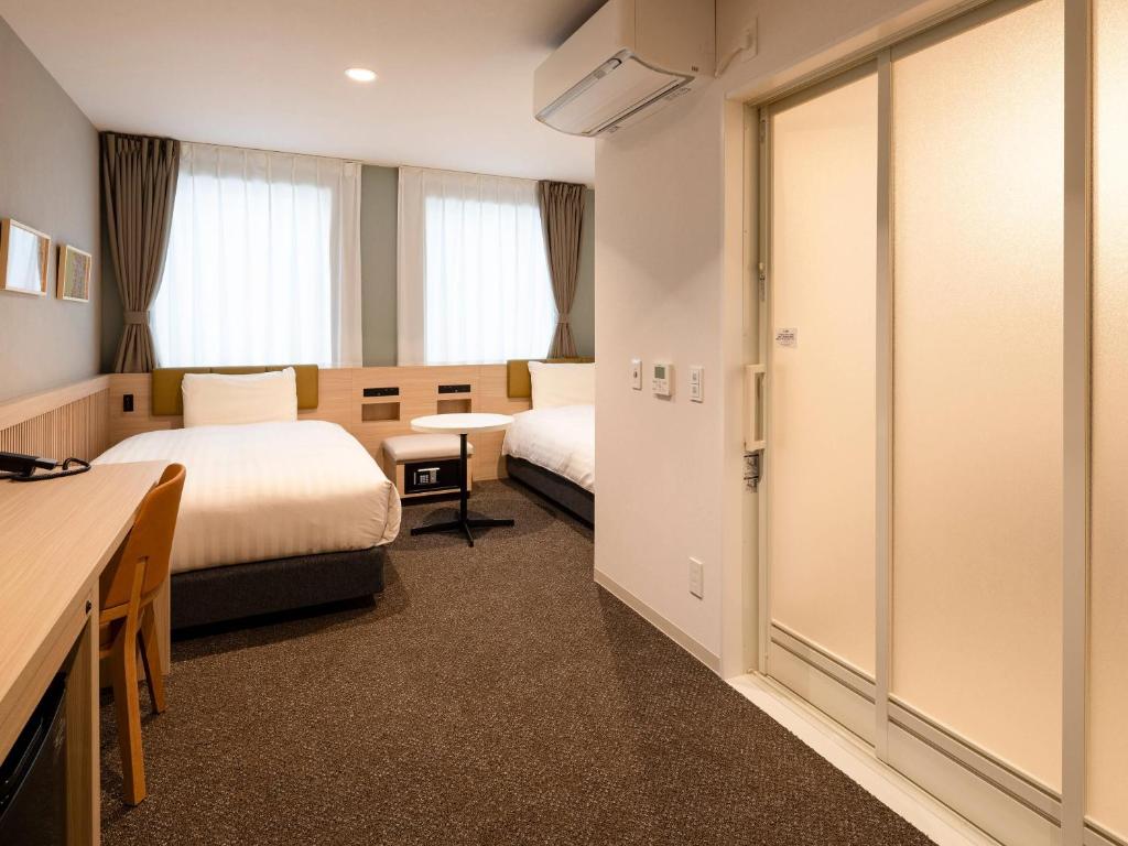 Postel nebo postele na pokoji v ubytování Comfort Hotel Mito