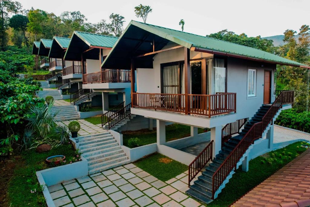 a row of houses with balconies and stairs at The Odyssey Coorg in Madikeri
