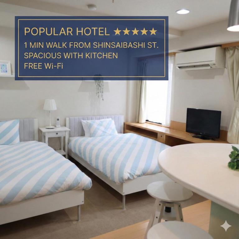 a hotel room with two beds and a table at Hotel LEAP in Osaka
