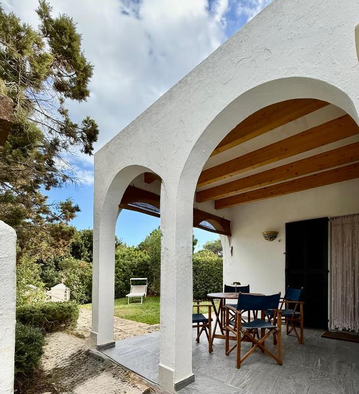 an outdoor patio with a table and chairs at Xalet Son Favaritx by GMHouse Menorca in Cala en Bosc