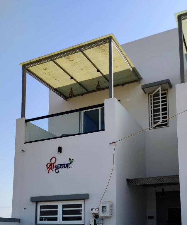 a building with a window on the side of it at Shree Krushn in Bhuj