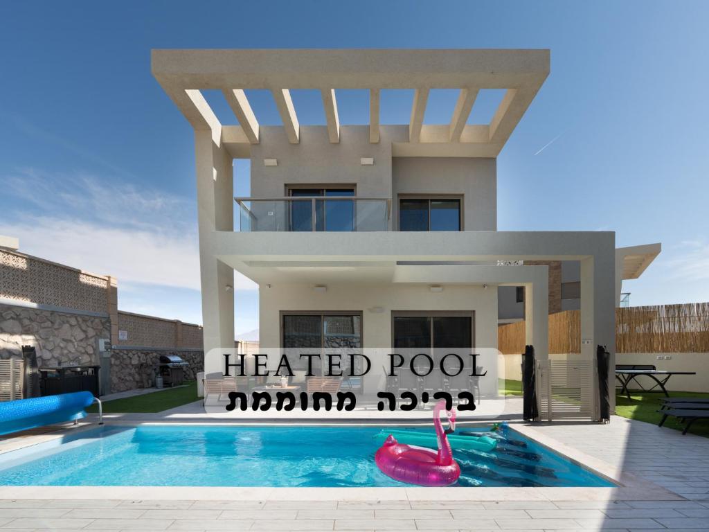 a house with a heated pool in front of it at Dreamy Rent- Aqua Vista eilat in Eilat