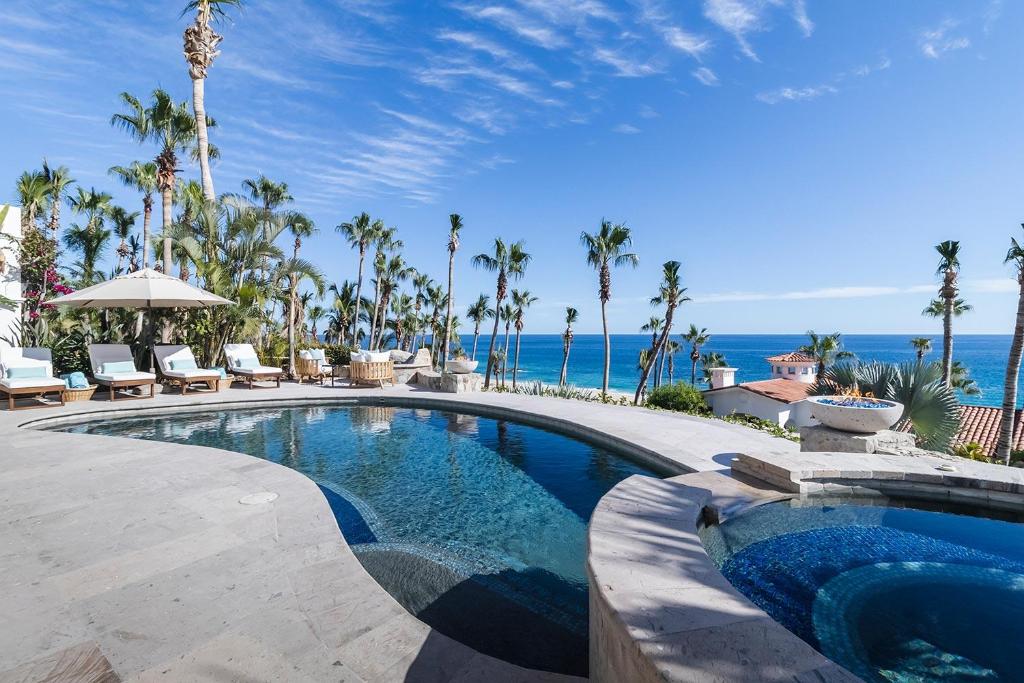 a swimming pool with a view of the ocean at Casa Sirena in San José del Cabo