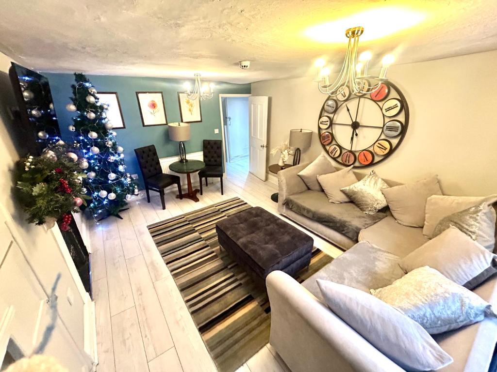 a living room with a christmas tree and a large clock at Hexham Town Centre, Market Place View in Hexham