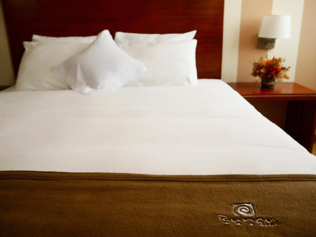 Ένα ή περισσότερα κρεβάτια σε δωμάτιο στο Hotel Boutique Runcu Miraflores