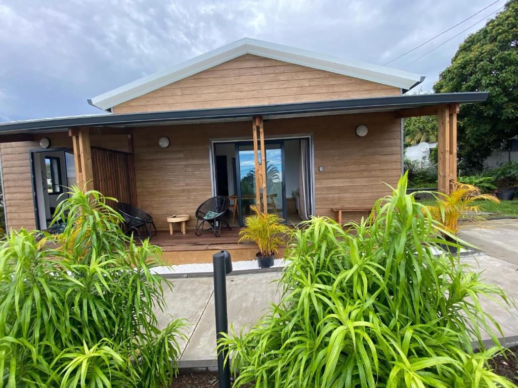 a small house with a porch with plants at O Coeur de l ouest bungalow Vanille Bourbon in Saint-Paul