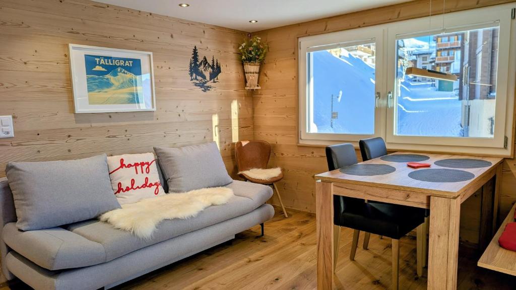 a living room with a couch and a table at Imhof Alpine B&B Apartments in Bettmeralp